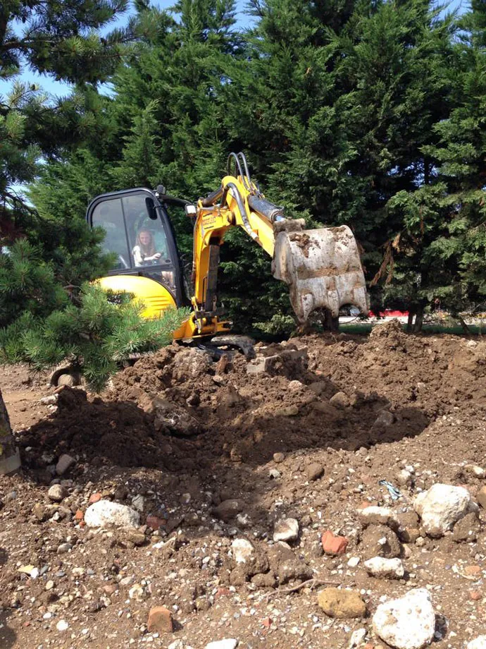 Cub driving a digger at diggerland