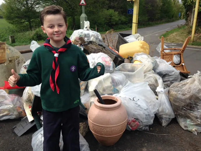 Cub posing next to litter