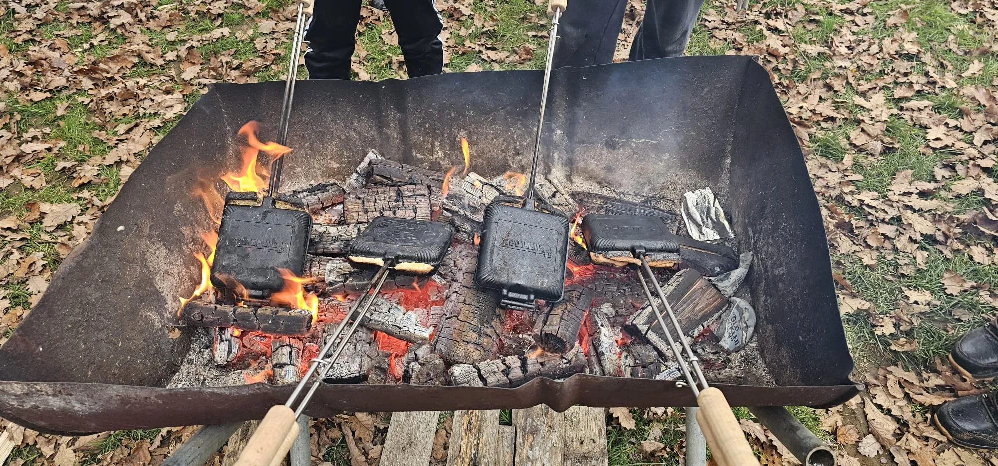 Sandwich toasters on fire embers